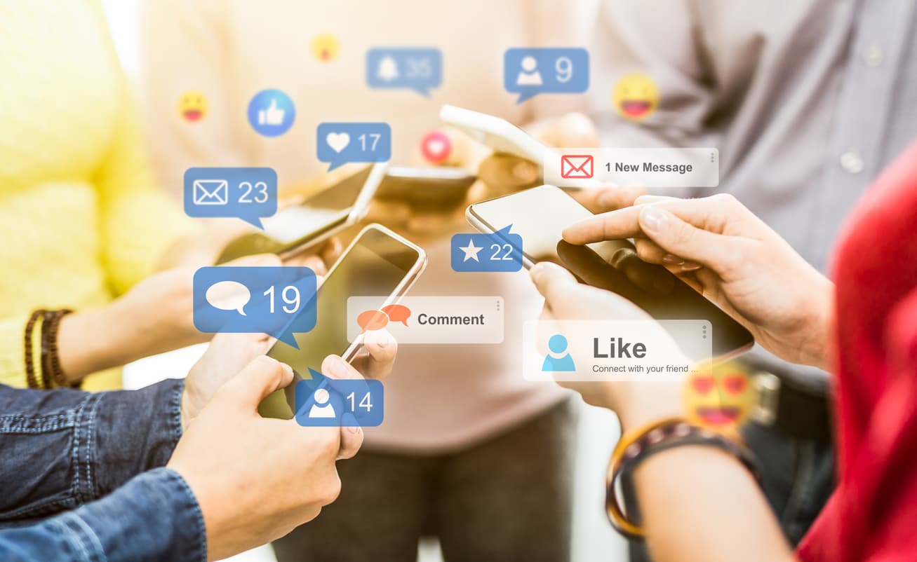 Five people holding phones through which they engage with a business