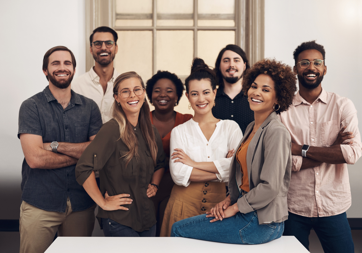 A group of people standing in front of a table