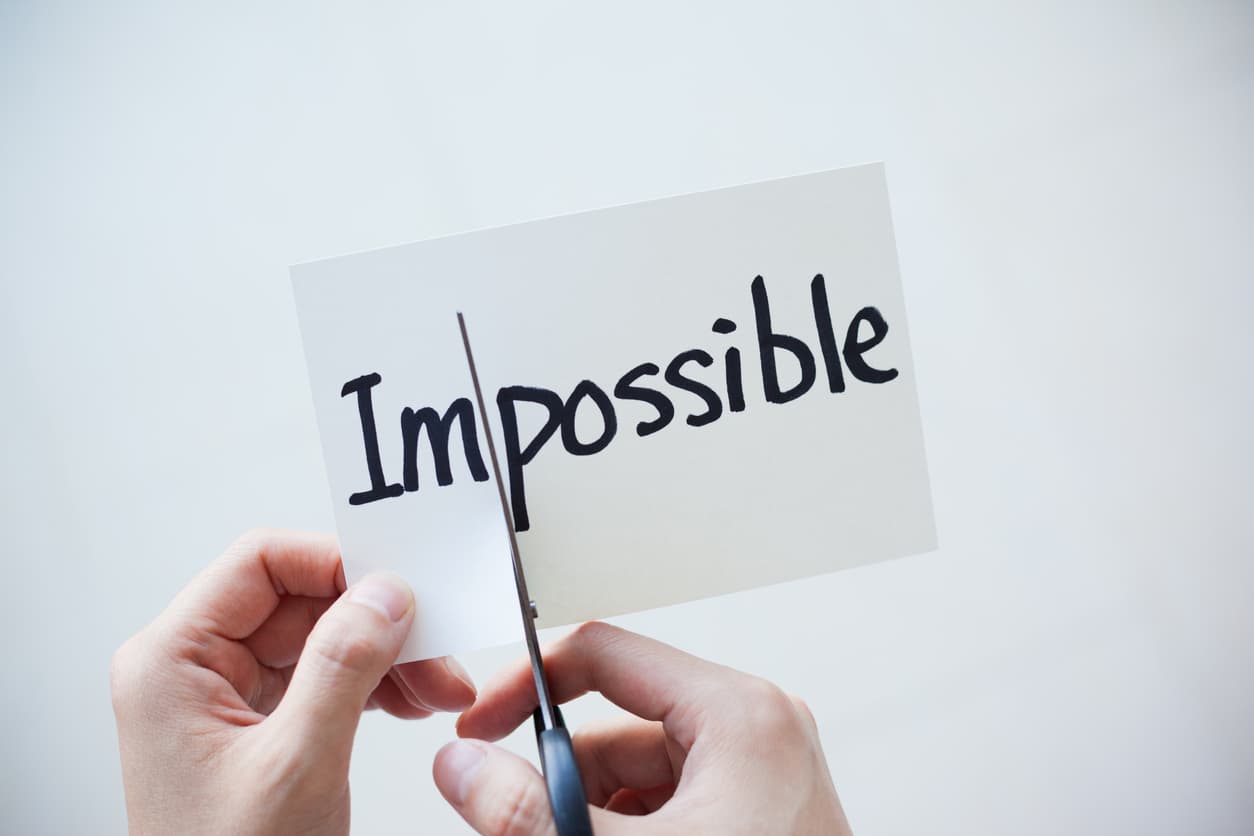 The word “impossible” is being cut by scissors to create the word “possible” in this article about how to nurture a growth mindset amongst your sales team.