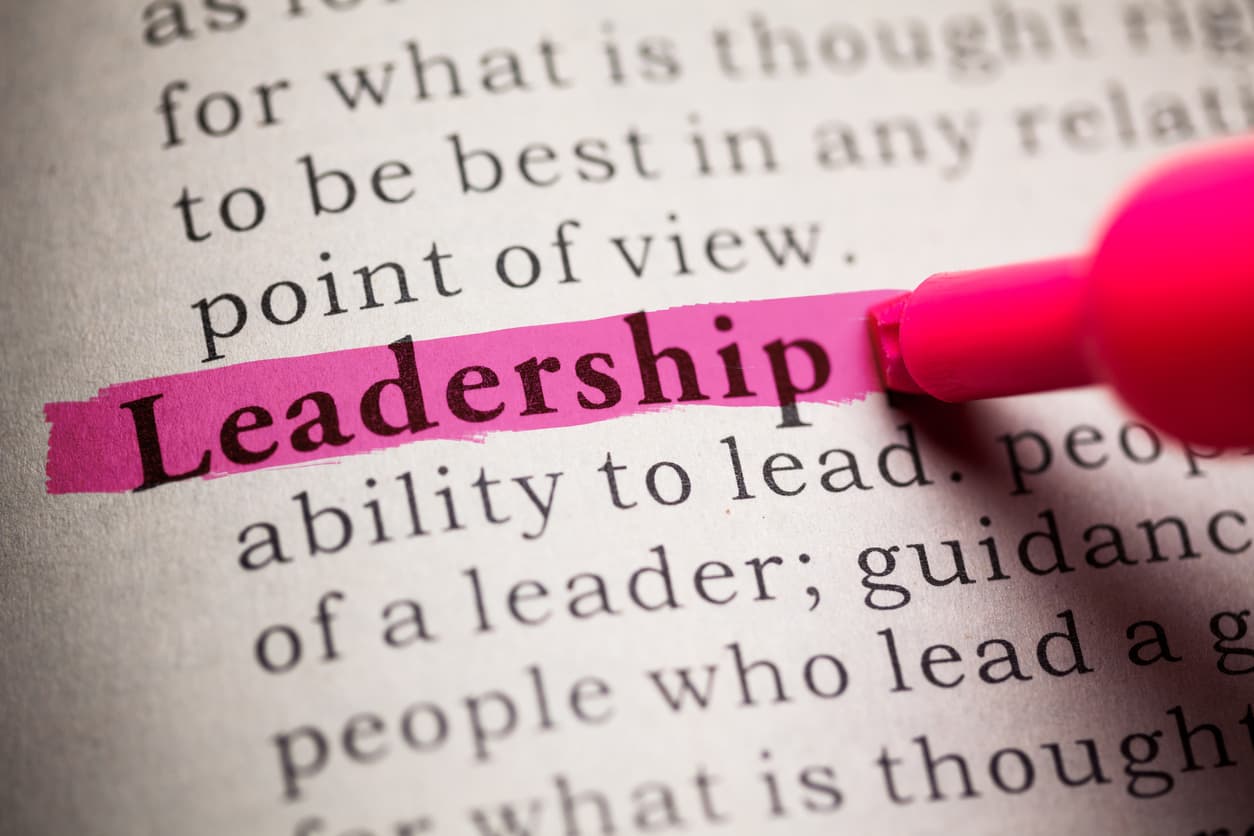 Open book with the word “Leadership” written and defined within