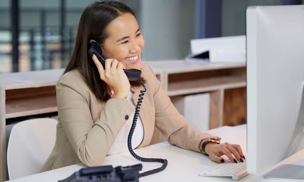 A woman making a sales call using prospecting best practices.