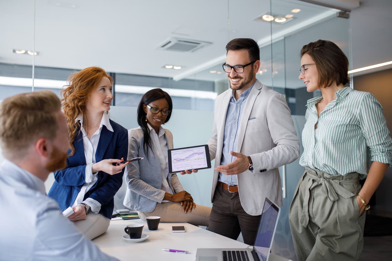 A manager encourages sales team feedback during a meeting.