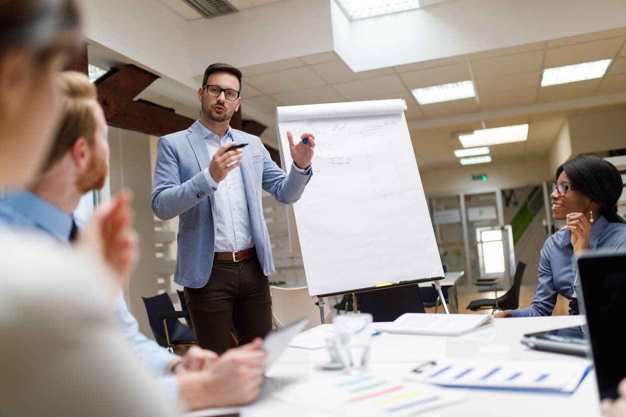 A man offering sales training to four other people.