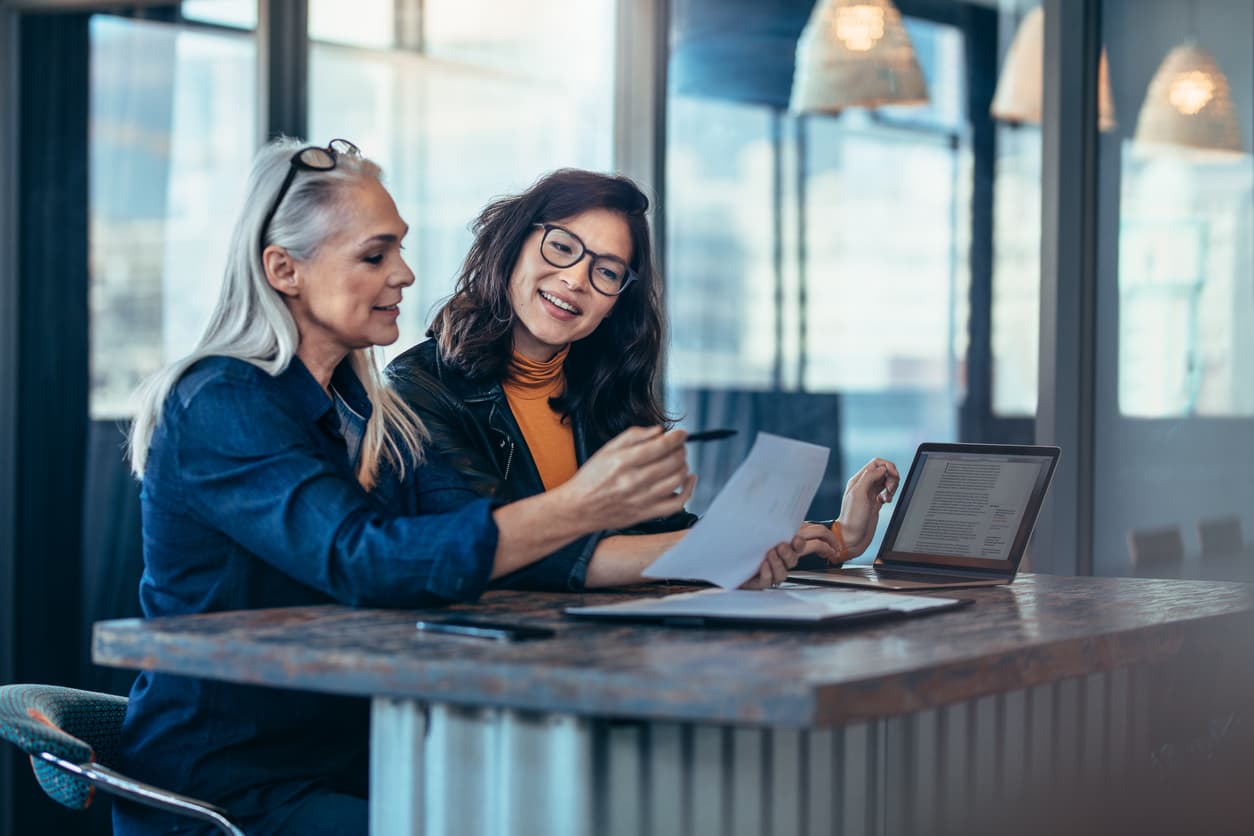 Two women sitting at a desk and preparing for scaling a sales team