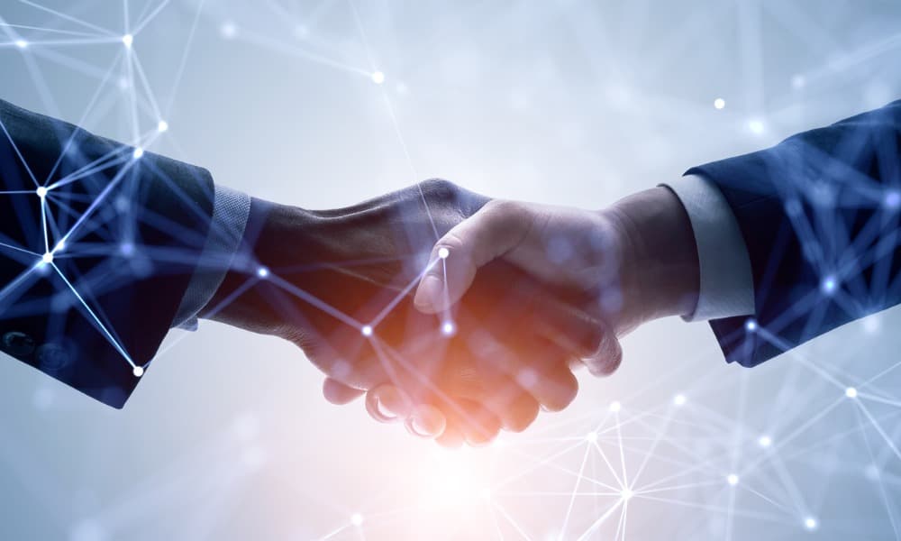 Close-up of two business people shaking hands, focused only on the hands.