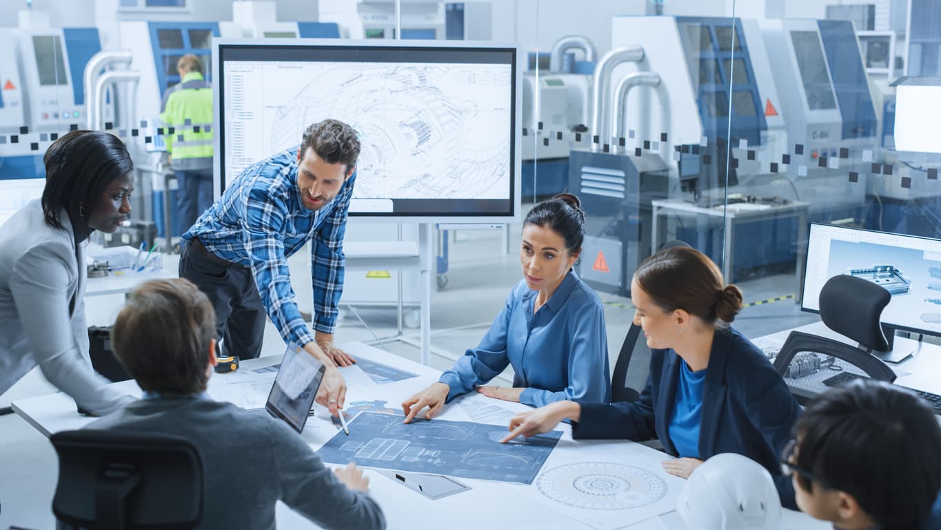 Workers around a table at a business meeting full of purpose-driven leadership