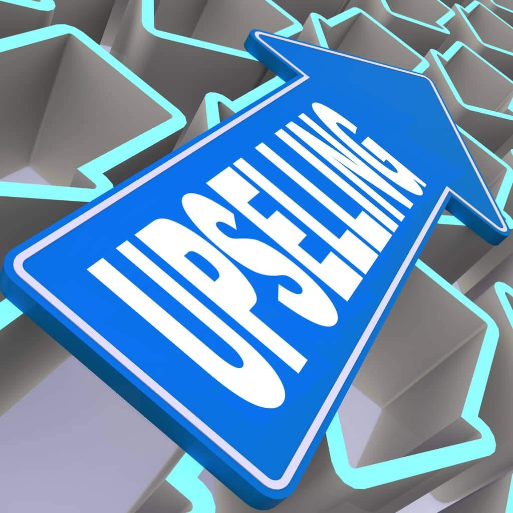 A background of arrows pointing to the left, with one overlayed on top and pointing right containing the word “upselling”